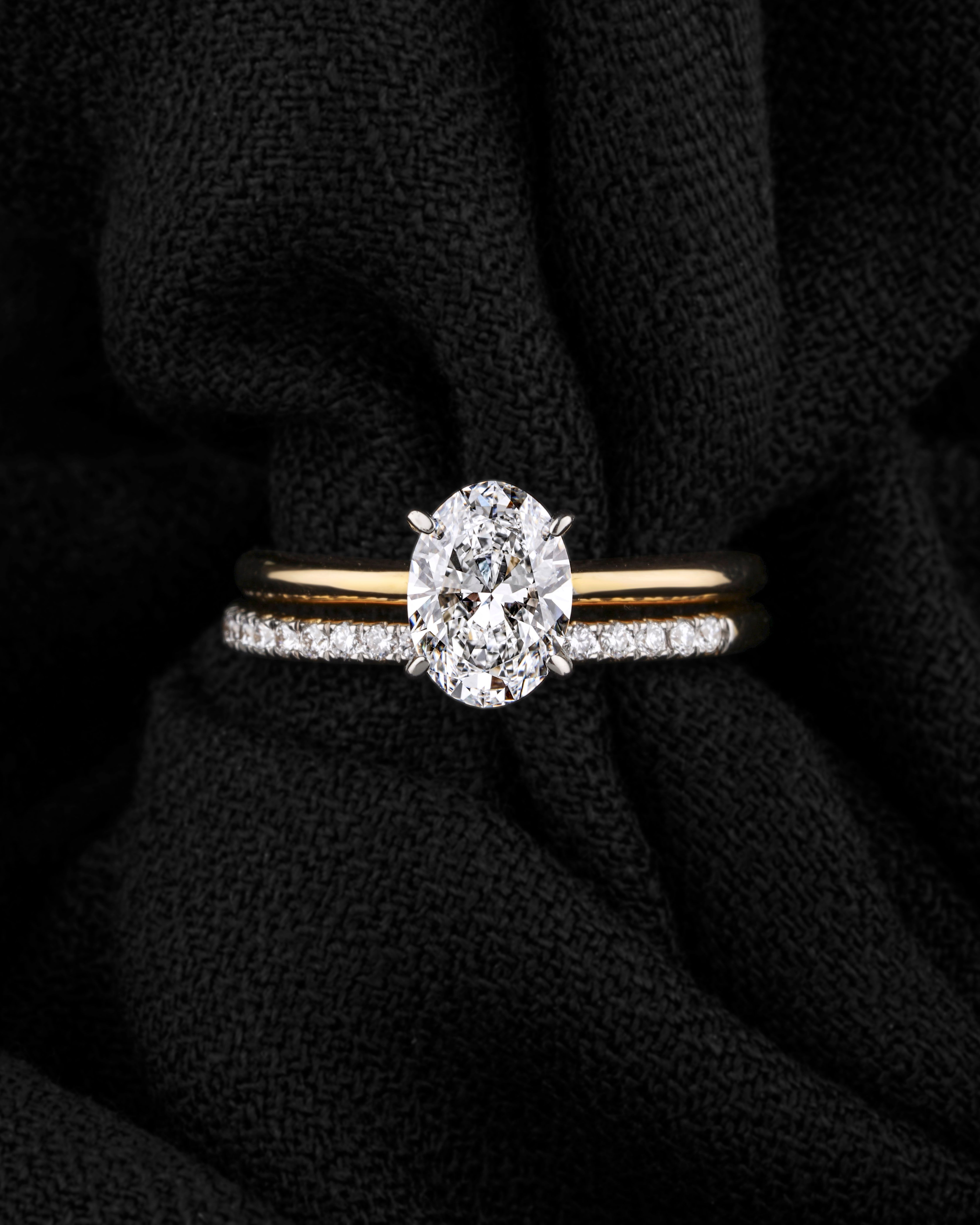 Stacked diamond rings on dark draped fabric