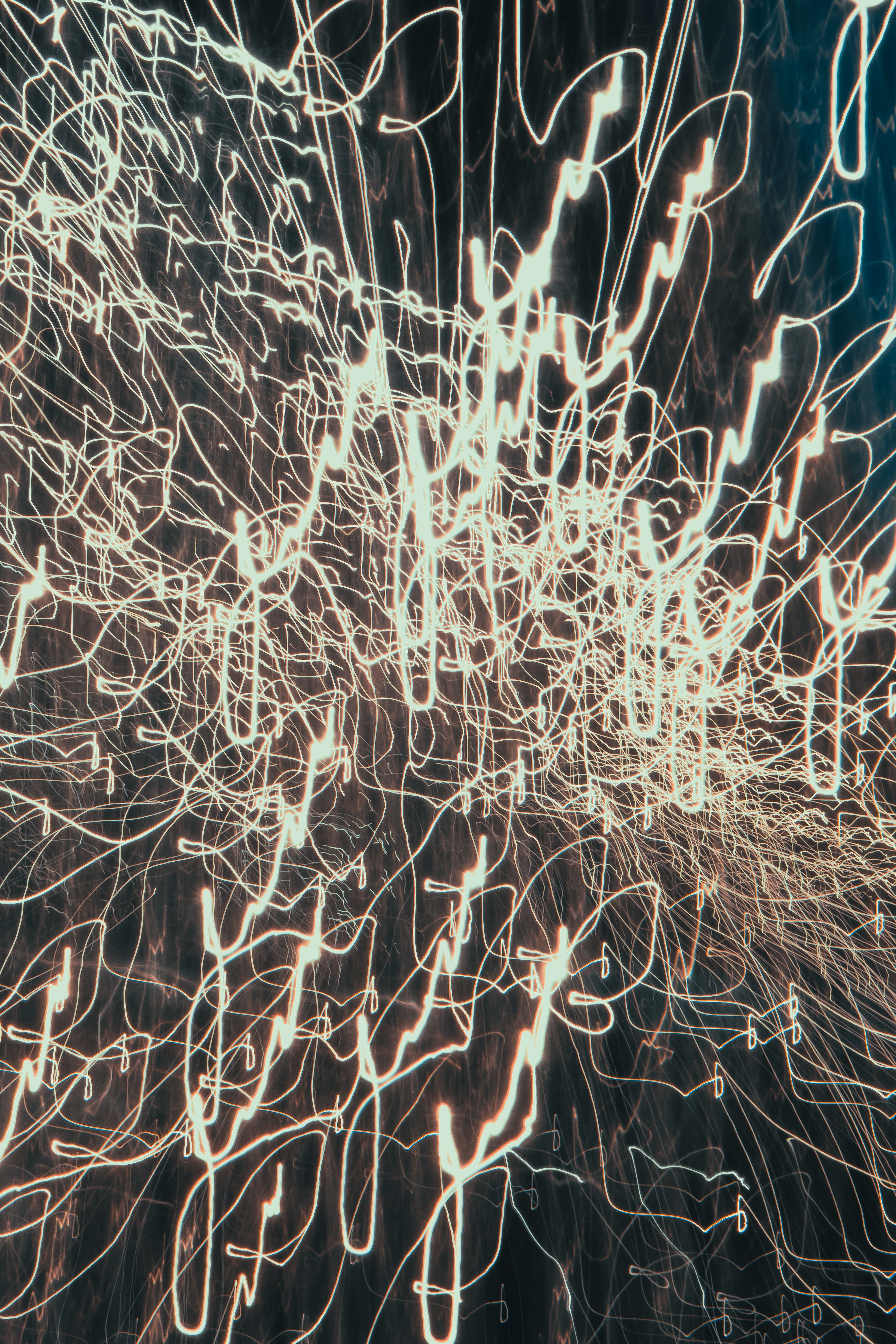 Tangled white and gold light-trail streaks against near-black
