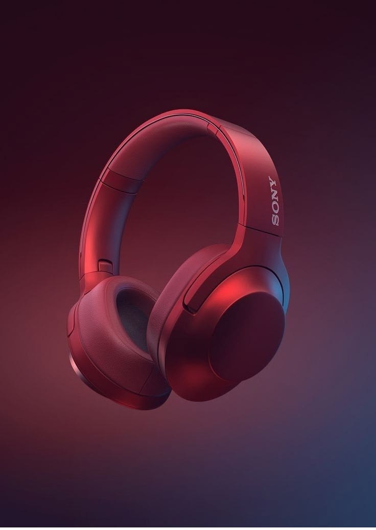 Red Sony over-ear headphones floating against a red-to-blue gradient backdrop