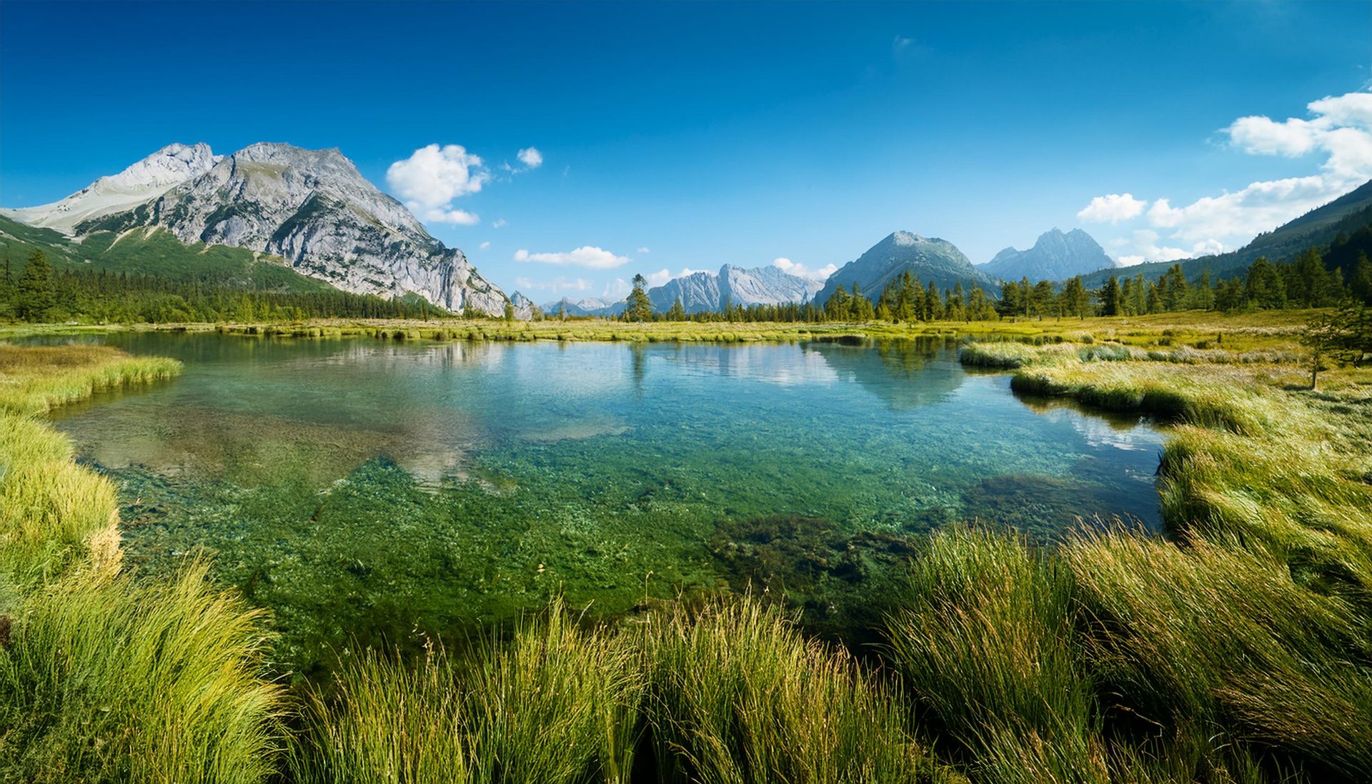 A deep turquoise alpine lake ringed by mountains