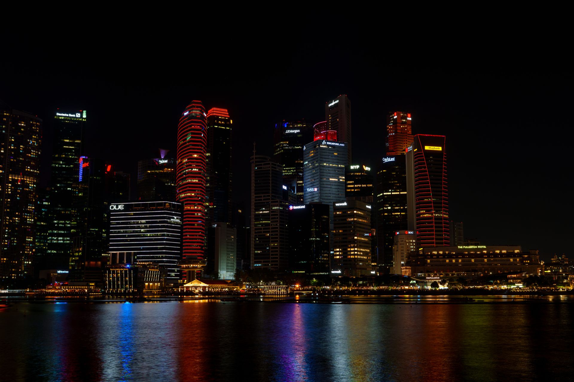 A city skyline at dusk with lights on across a wide urban panorama