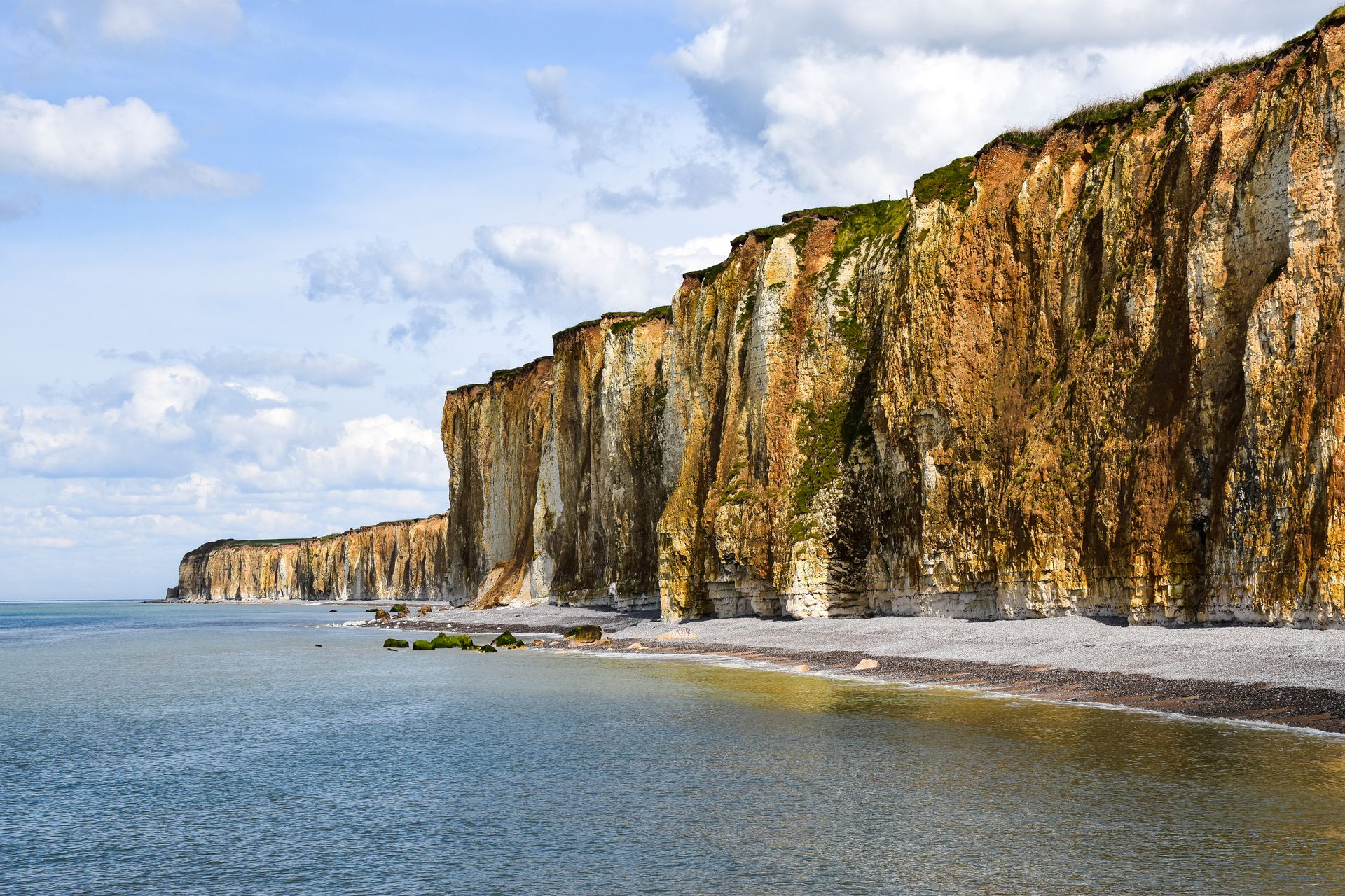 A long panoramic coastline with steep cliffs meeting the ocean