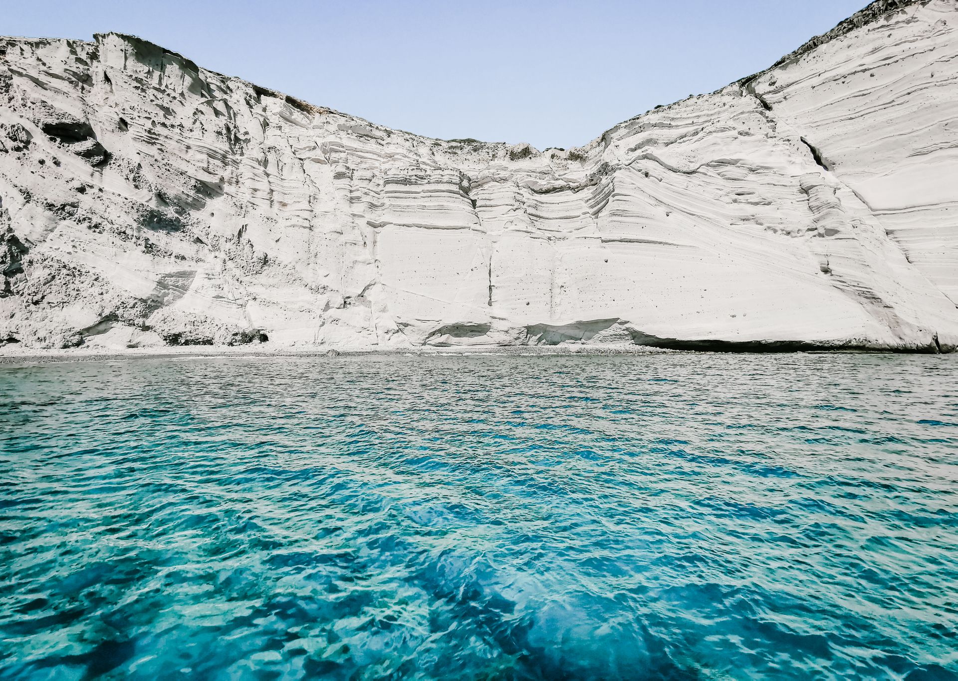 A turquoise coastline with cliffs meeting bright blue-green water